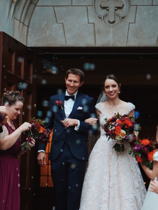 use tips to help make your wedding less less stressful so you can enjoy your day like this happy bride and groom as they walk down the aisle out of the church