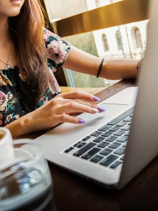 a cup of coffee at work like this woman has on her desk makes the Necta Krea a great coffee machine for the workplace kitchen
