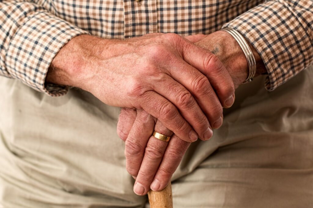 elderly man's hands on cane