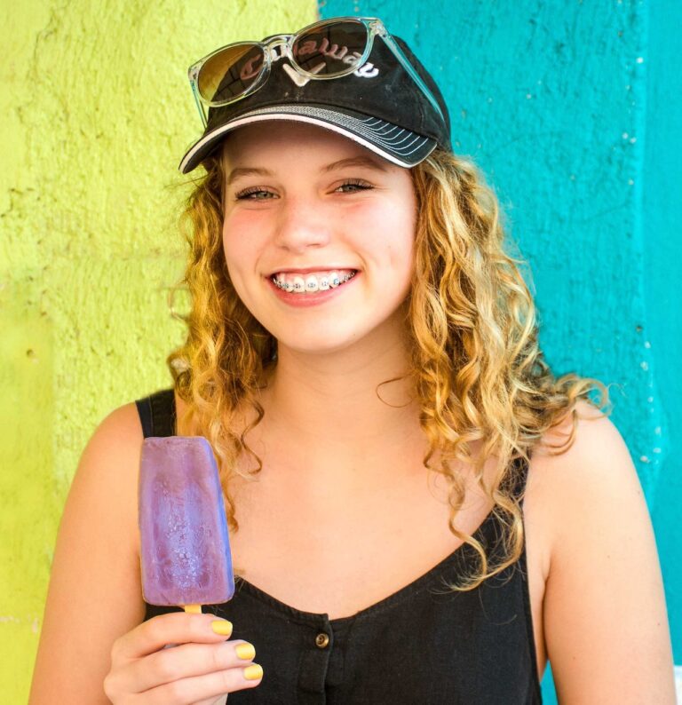 girl wearing braces after learning when to get braces