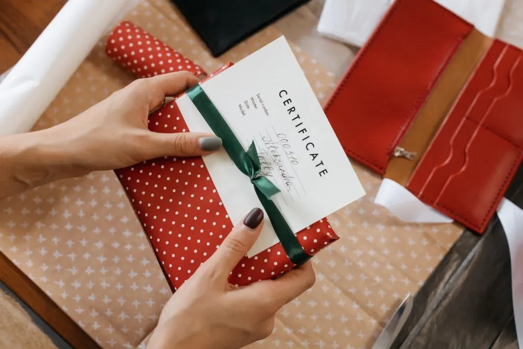 woman holding a gift certificate as a corporate gifting gift idea