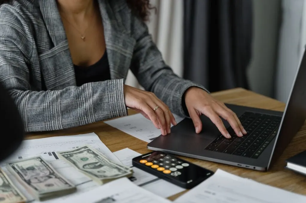 woman working on computer to make a budget for college