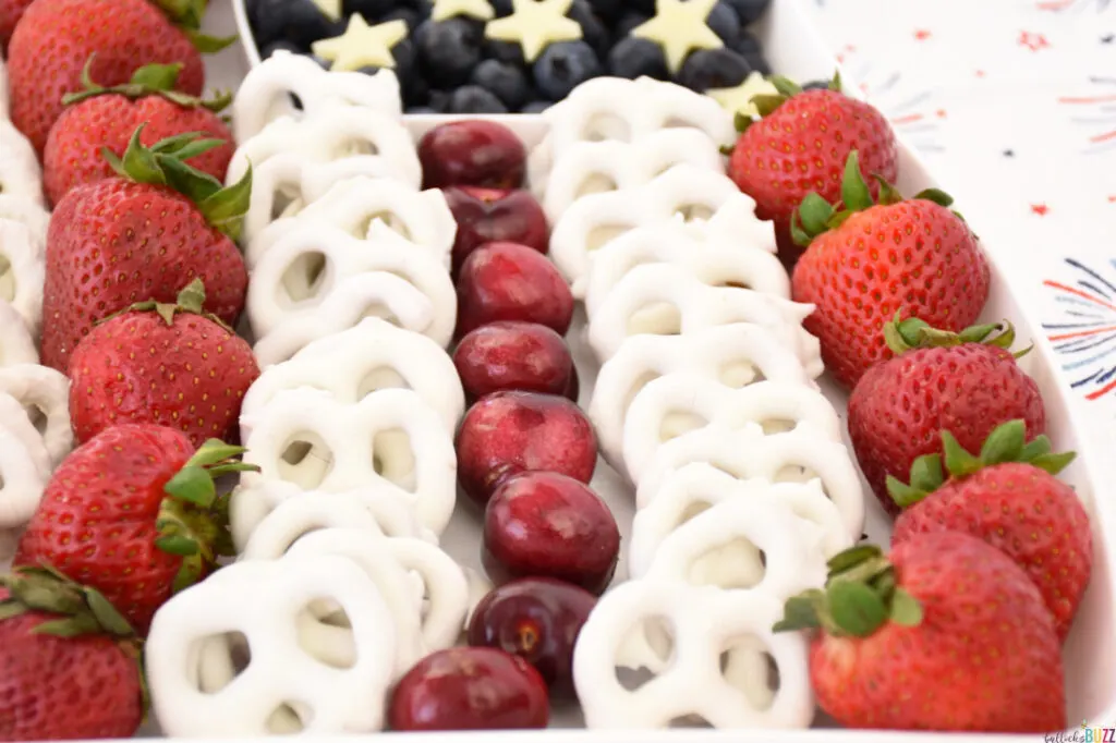 close up of rows of fruit making up red and white stripes of American flag