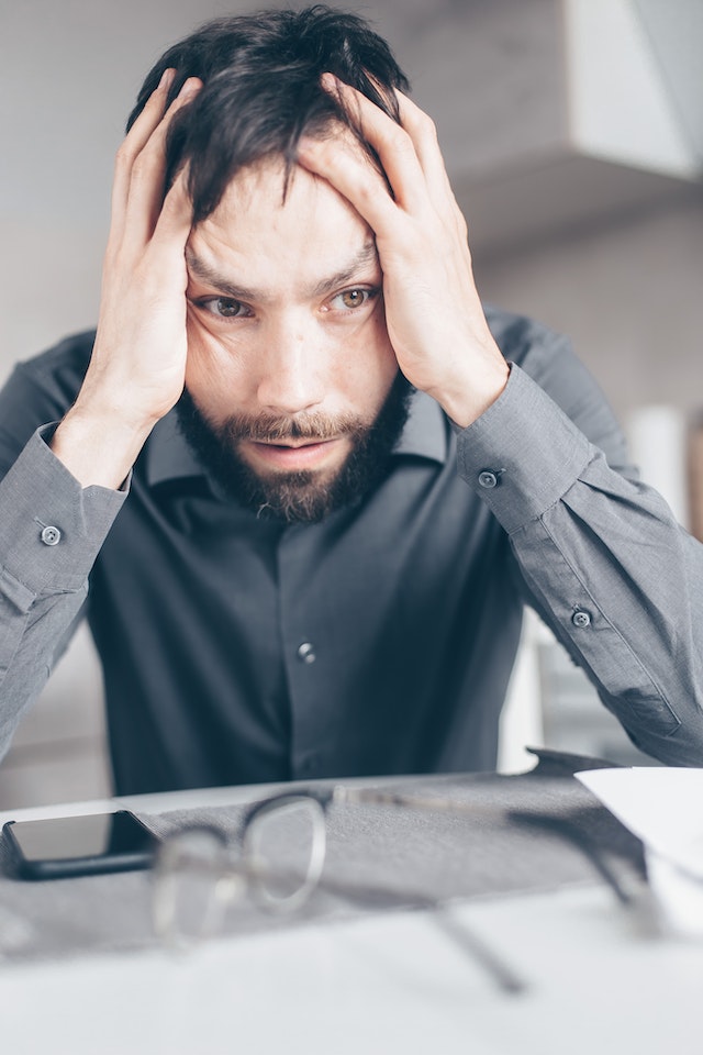 stressed-out man worried needing an accounts receivable tool to help recover debt