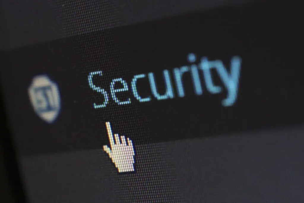 person pointing their mouse at the word security to see the benefits of security management system software