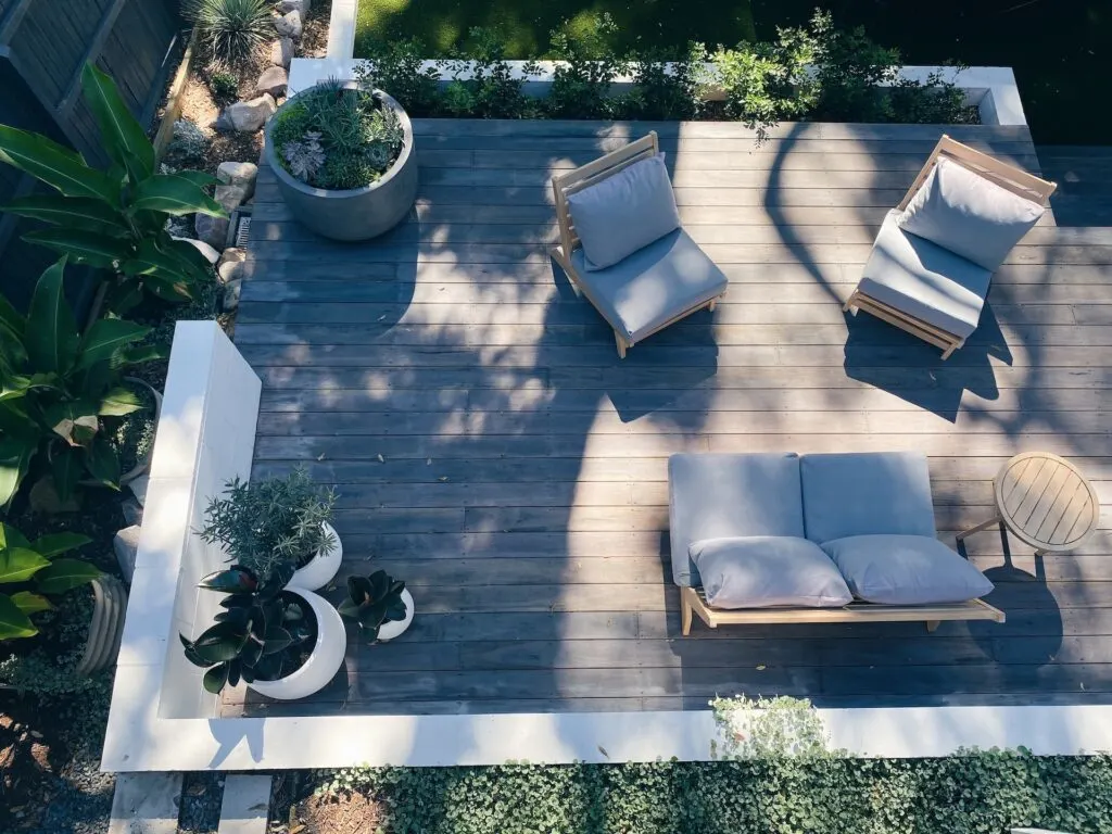 creating a cohesive look by using the same pillows on furniture is one of the easiest ways to make your backyard feel more luxurious