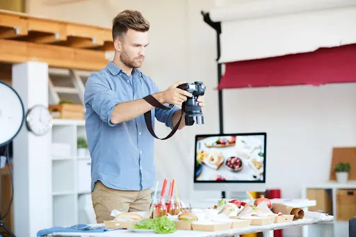 man taking photo of food from above as part of choosing the right angle; another of our food photography tips 