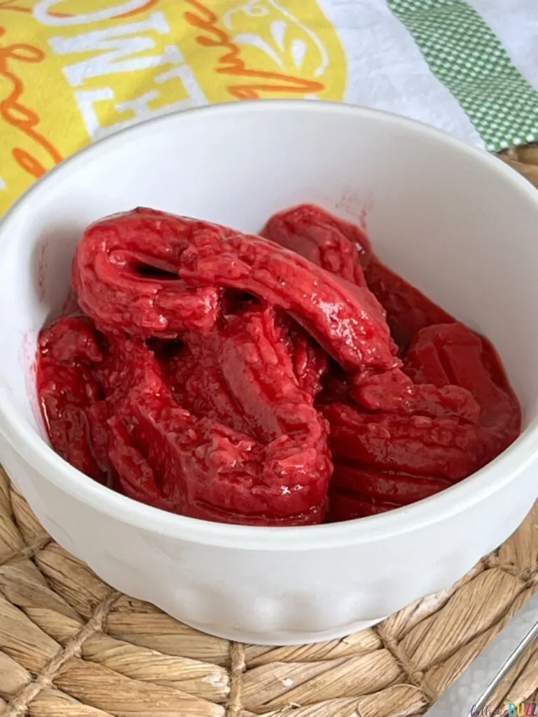 close up of raspberry sorbet in a white bowl