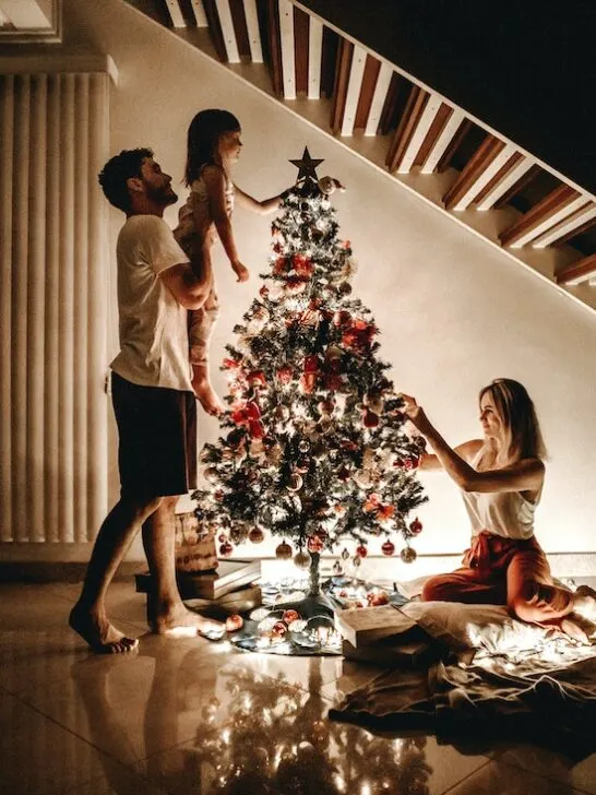 A family decorating their Christmas tree is one of the most enjoyable Christmas activities.