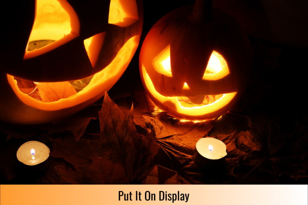 two carved jack o lanterns lit up at night