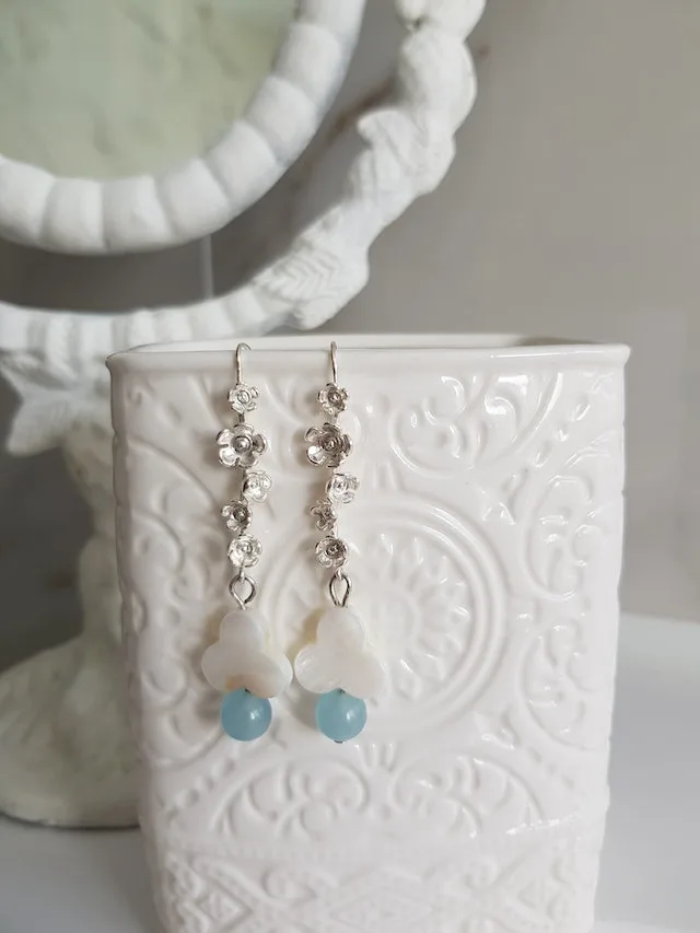 long fashion earrings dangling from the side of a jewelry holder