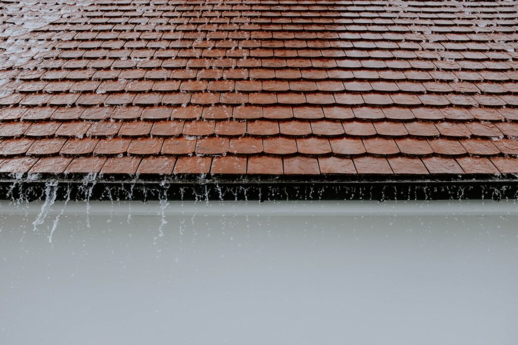 rain falling on a tile roof with clean gutters