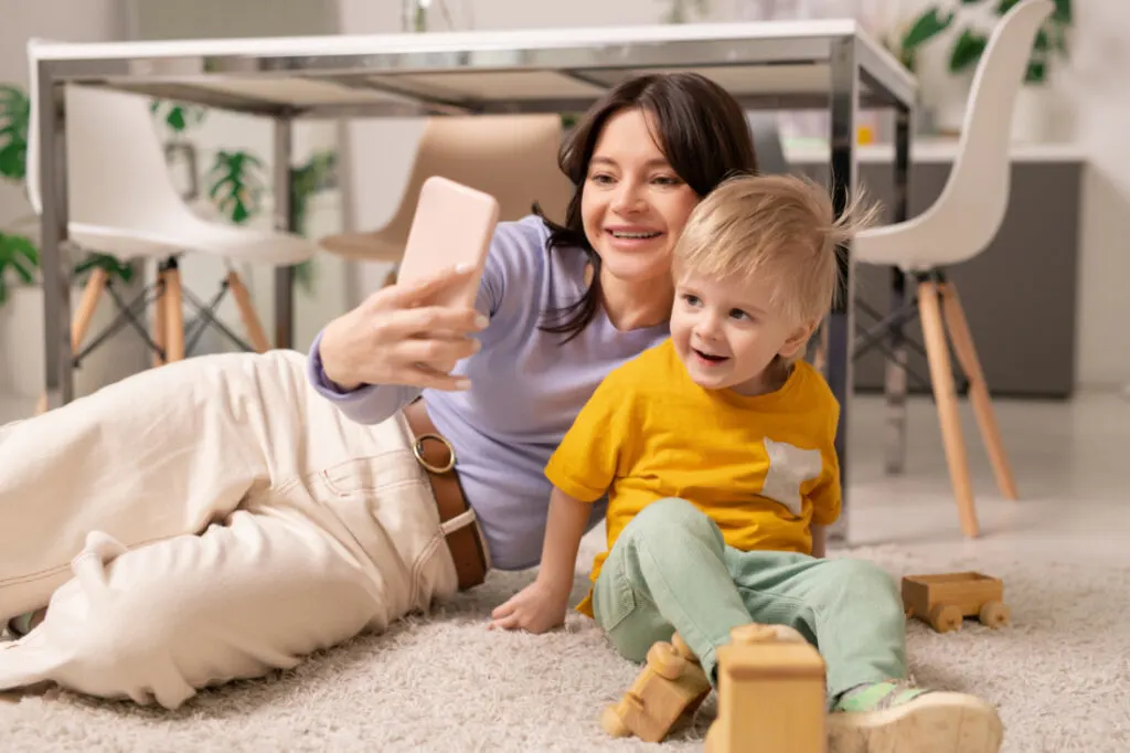 woman posing with her son for the perfect selfie