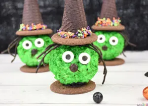 Close up of Halloween Popcorn Ball Witches treat made from popcorn balls, ice cream cones, cookies and candy.