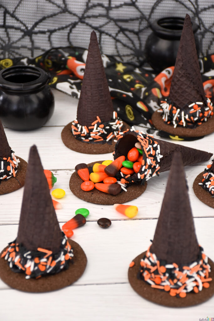 A Candy-Filled Witch Hat cracked open so its candy is spilling out onto the table.