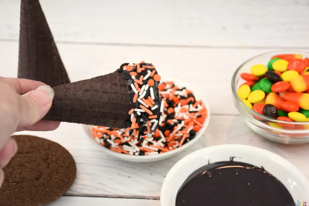 Roll candy-coated cone in Halloween sprinkles.