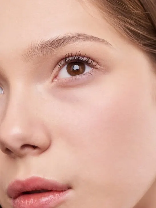 A close up picture of woman's face with gorgeous skin after she learned how to choose the right serum for your skin type.