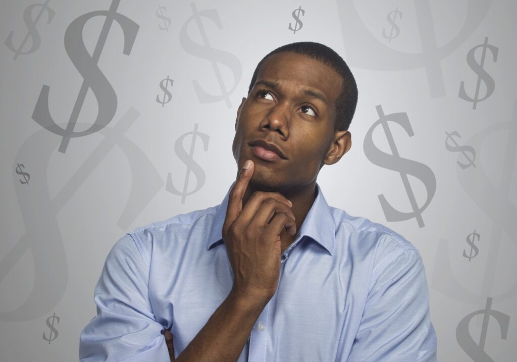 man thinking about money and steps towards becoming debt-free