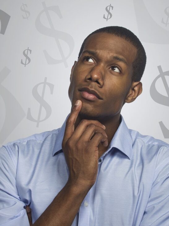 man thinking about money and steps towards becoming debt-free