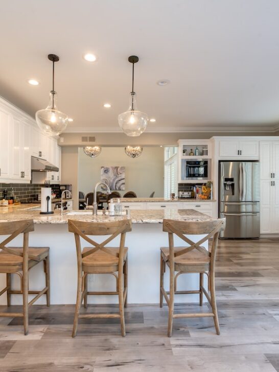 A beautifully remodeled kitchen with white cabinets and a gray backsplash. Take a look at these common signs your kitchen needs an upgrade.