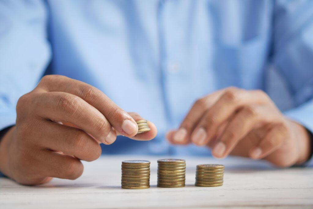 man stacking coins on a table