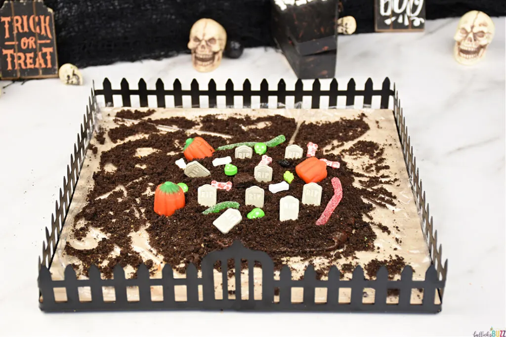 Use candy tombstones, bones, pumpkins, worms, and more to decorate the graveyard.