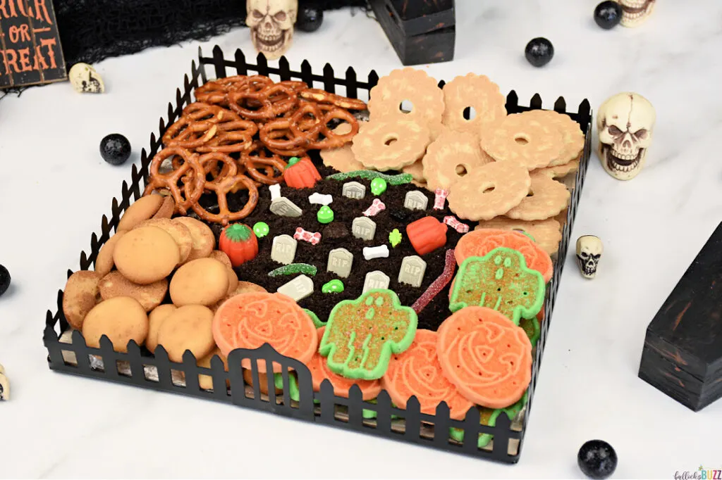 A graveyard-themed Halloween Frosting Board with cookies and frosting.