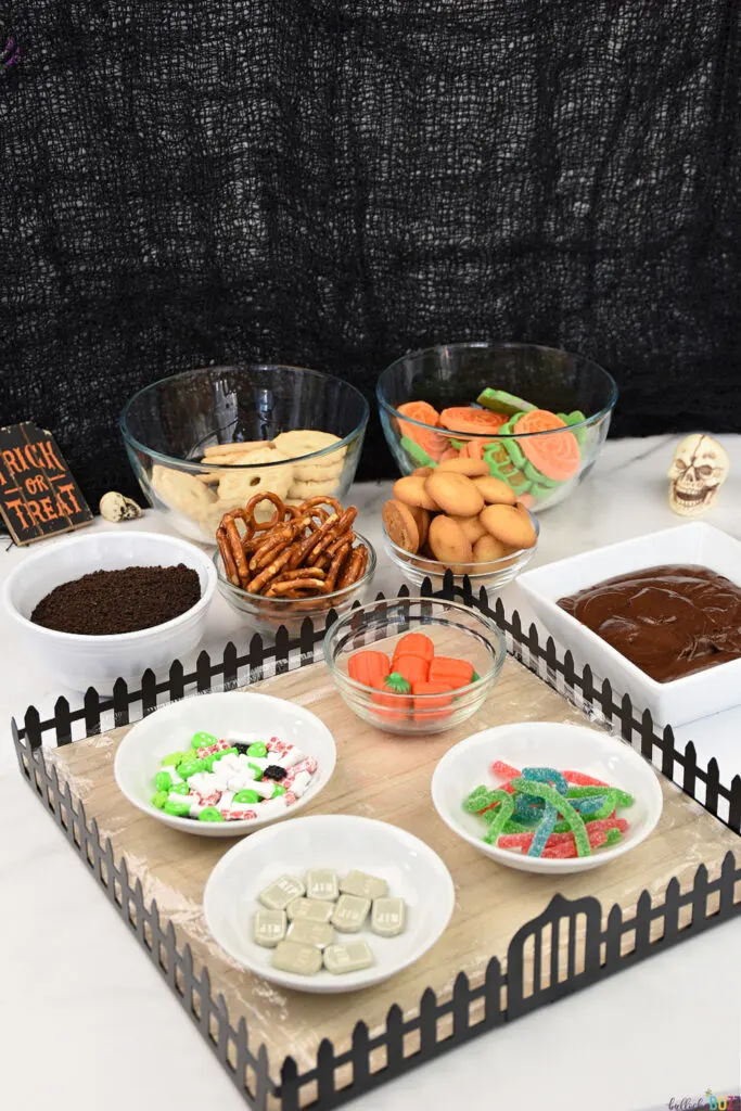 Ingredients to make graveyard halloween frosting board laid out in bowls