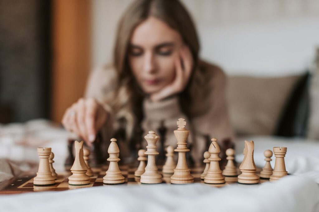 Girl playing chess as one of the fun night-in activities suggested in this post.