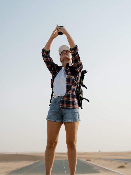A woman taking selfie in the desert as she finds meaning in traveling to avoid feeling lost in life.
