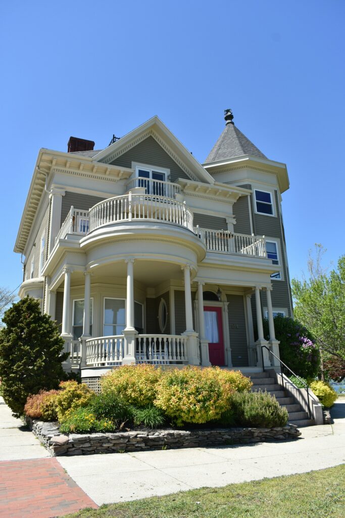 Gray and white Victorian style home after undergoing several home exterior remodeling projects