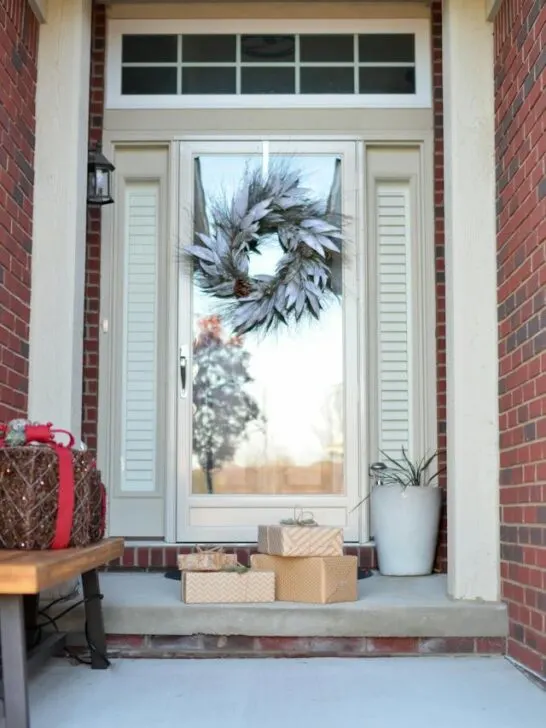 Front porch decorated for Christmas using these outdoor holiday decorating tips.