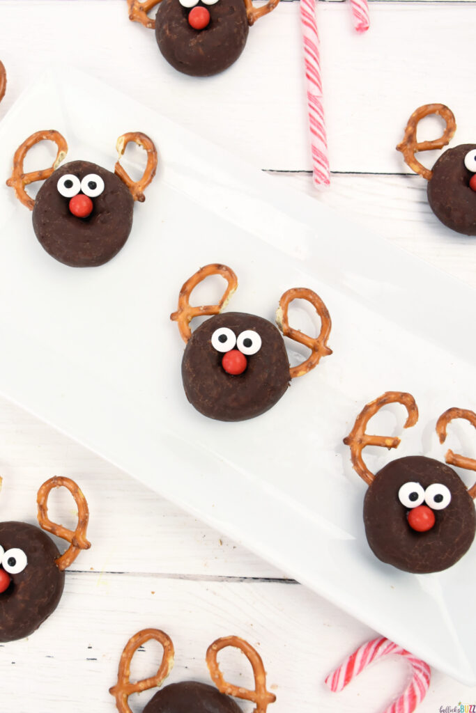 a plate full of chocolate donuts made into reindeer donuts