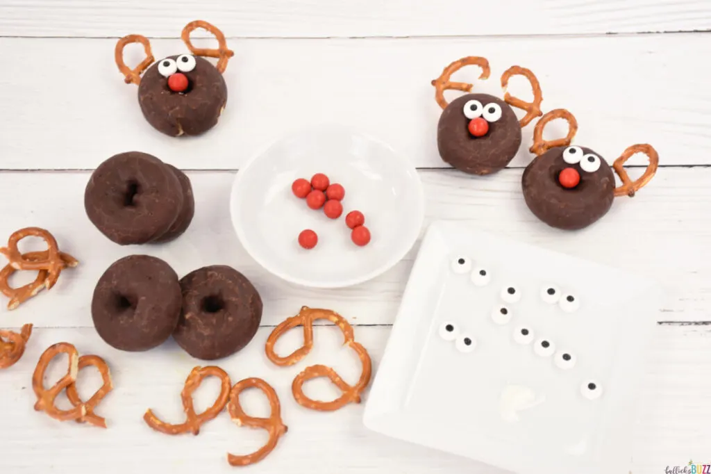 Ingredients to make donut reindeer laid out on a white background