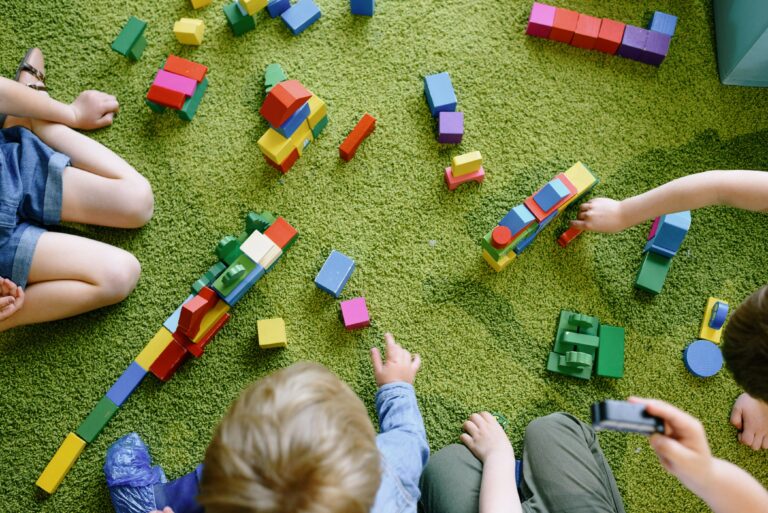 Kids playing with colorful blocks is an example of the role of play in special education.