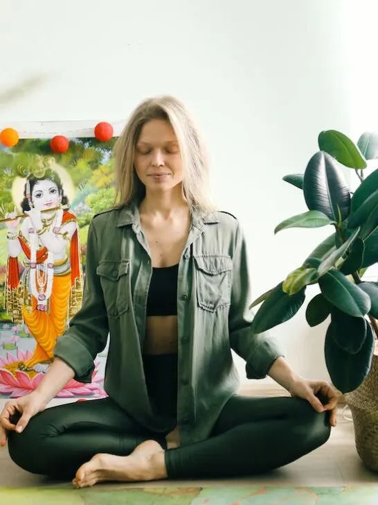 Woman meditating as part of focusing on wellness.