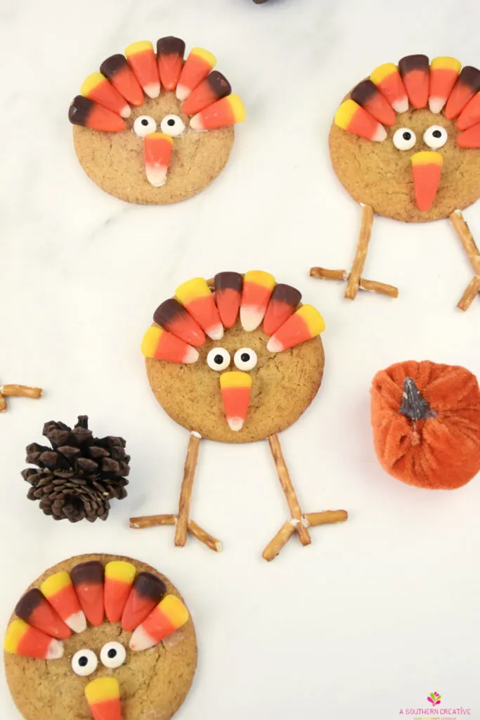 Thanksgiving Turkey Cookies made of Snickerdoodle Cookies, candy eyes, candy corn and pretzels.