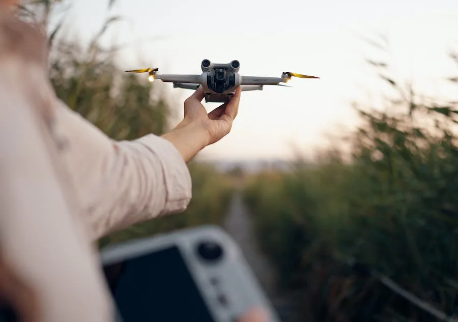 A person preparing to fly a drone outside, which is just one of the many ways technology makes the outdoors more fun