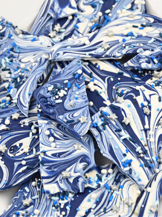 Close up image of the finished Hanukkah Bark Candy on a white plate ready to serve