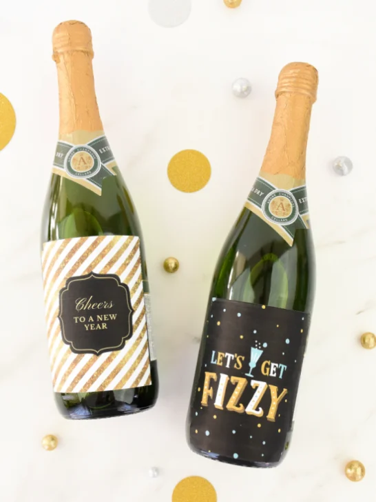 Two bottles with the printable New Years Eve wine bottle labels set against a white background
