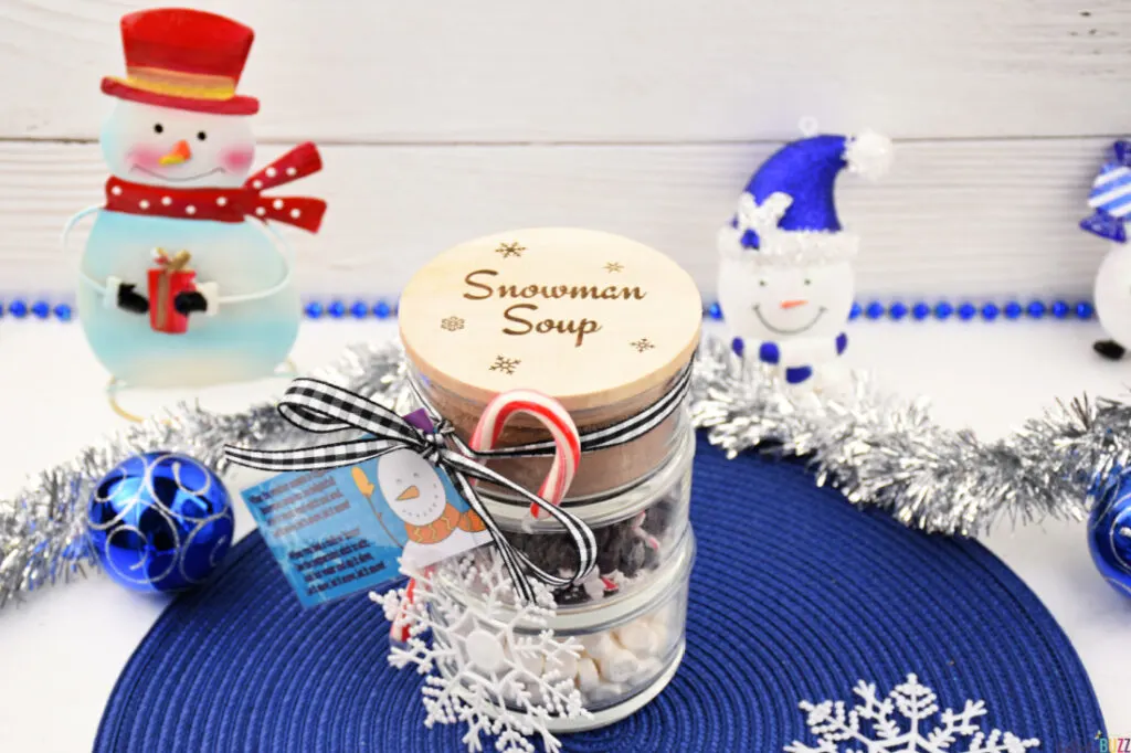 Completed DIY Snowman Soup Hot Cocoa Jar creating a festive holiday display