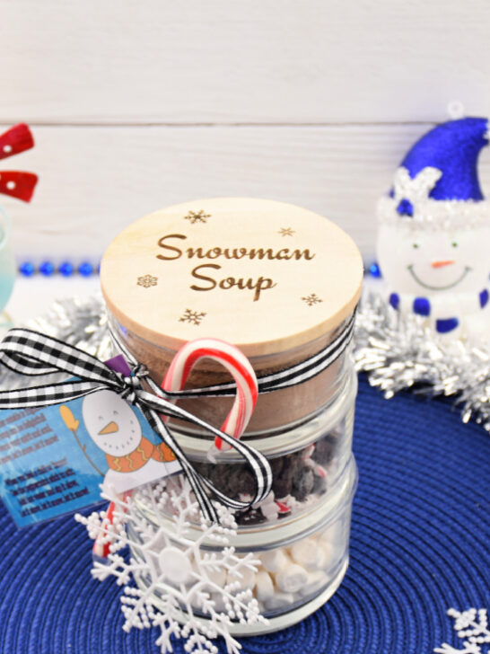 Completed DIY Snowman Soup Hot Cocoa Jar creating a festive holiday display