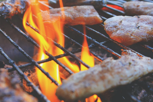 meat on a grill over open flame