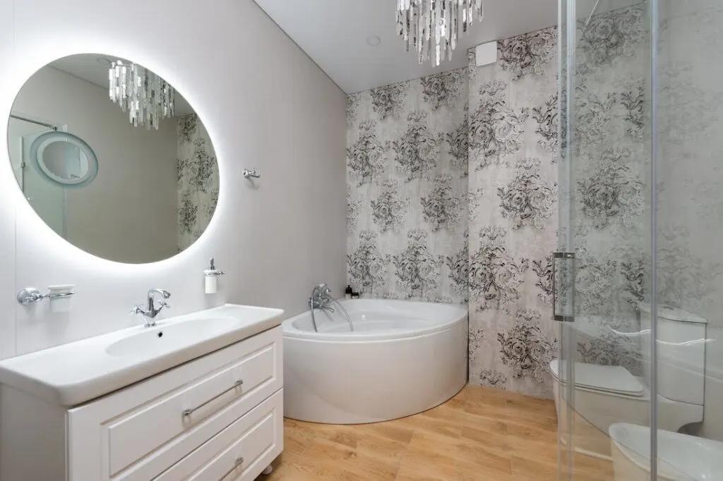 Using a chandelier like the one in this bathroom is another of the easiest and most effective ways of enhancing the ceilings in your home.