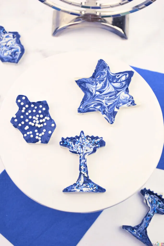 Finished Homemade Hanukkah Candy shaped with cookie cutters to look like Menorah, Dreidel, and Star of David.