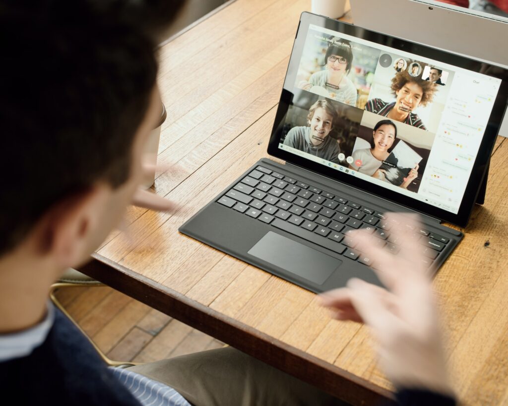 man having video conference on his laptop just one example of tech trends now and to come