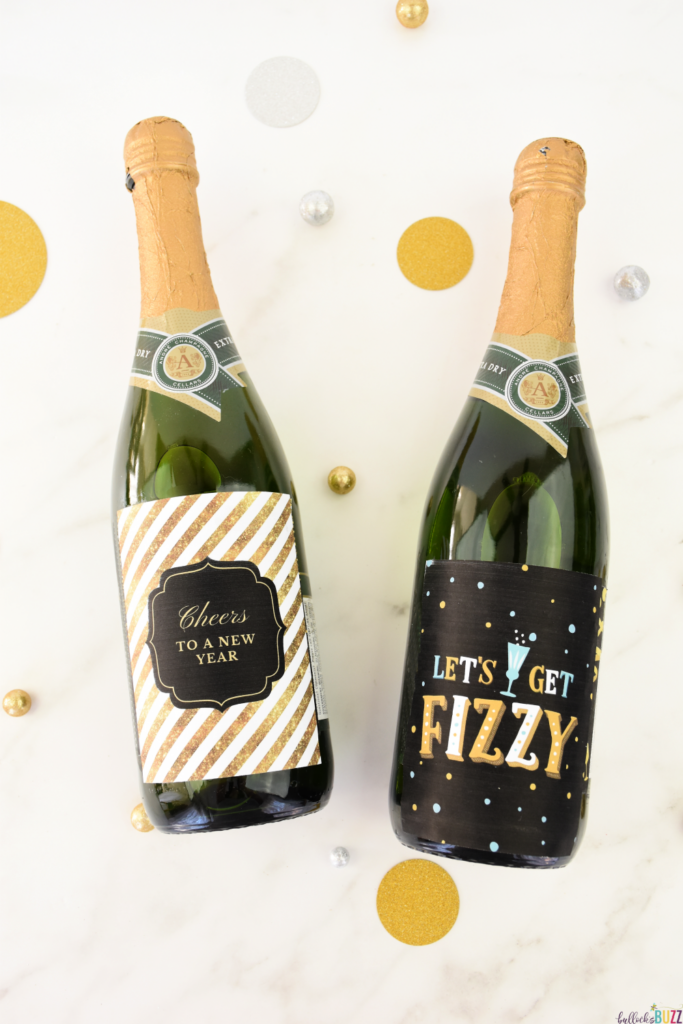 Two wine bottles with elegant New Year's Eve printable wine bottle labels, set against a white background adorned with gold and silver circles, embodying the festive spirit of the holiday.