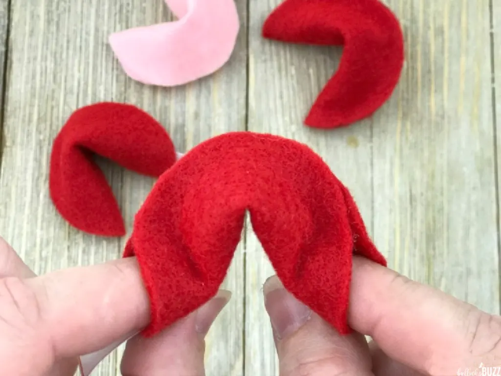 Use fingers to pooch out the flet and make it look more like fortune cookie shape
