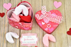A heart shaped box full of DIY felt fortune cookies for Valentines Day