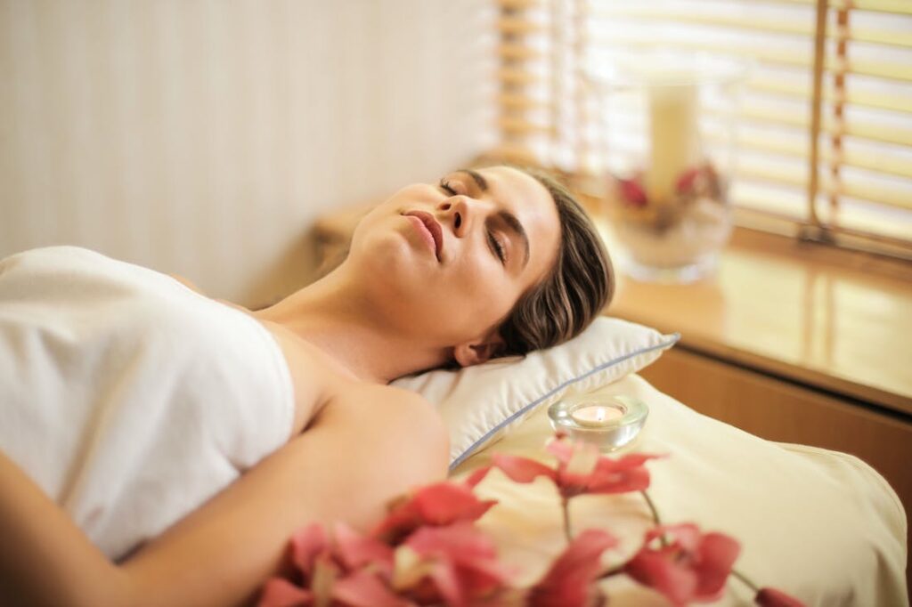 Woman relaxing on a massage table in a spa showing the holistic approach to beauty from beauty experts